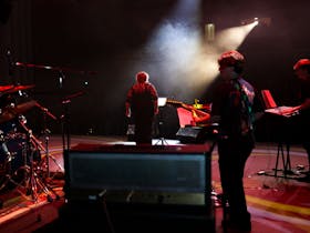 Charlee on stage with light filtering through