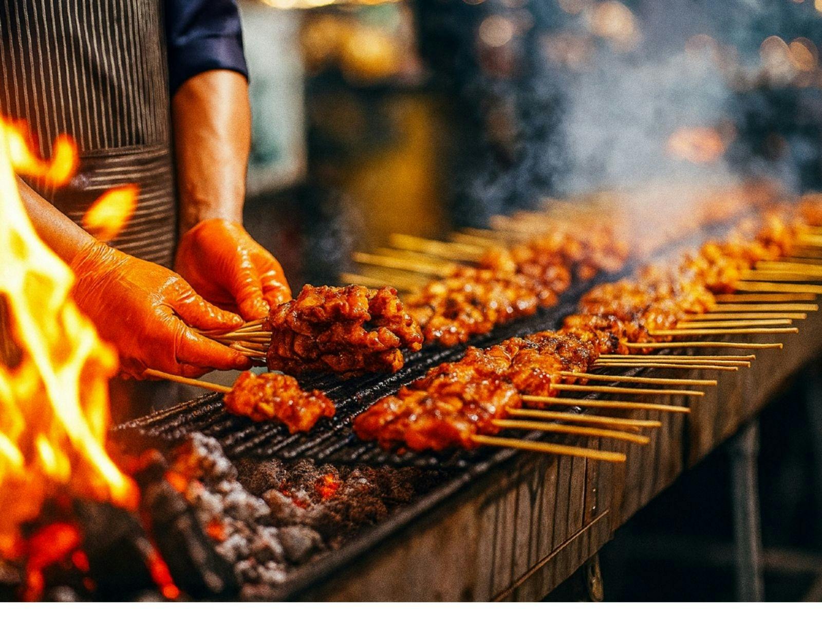 Satay sticks cooking on BBQ