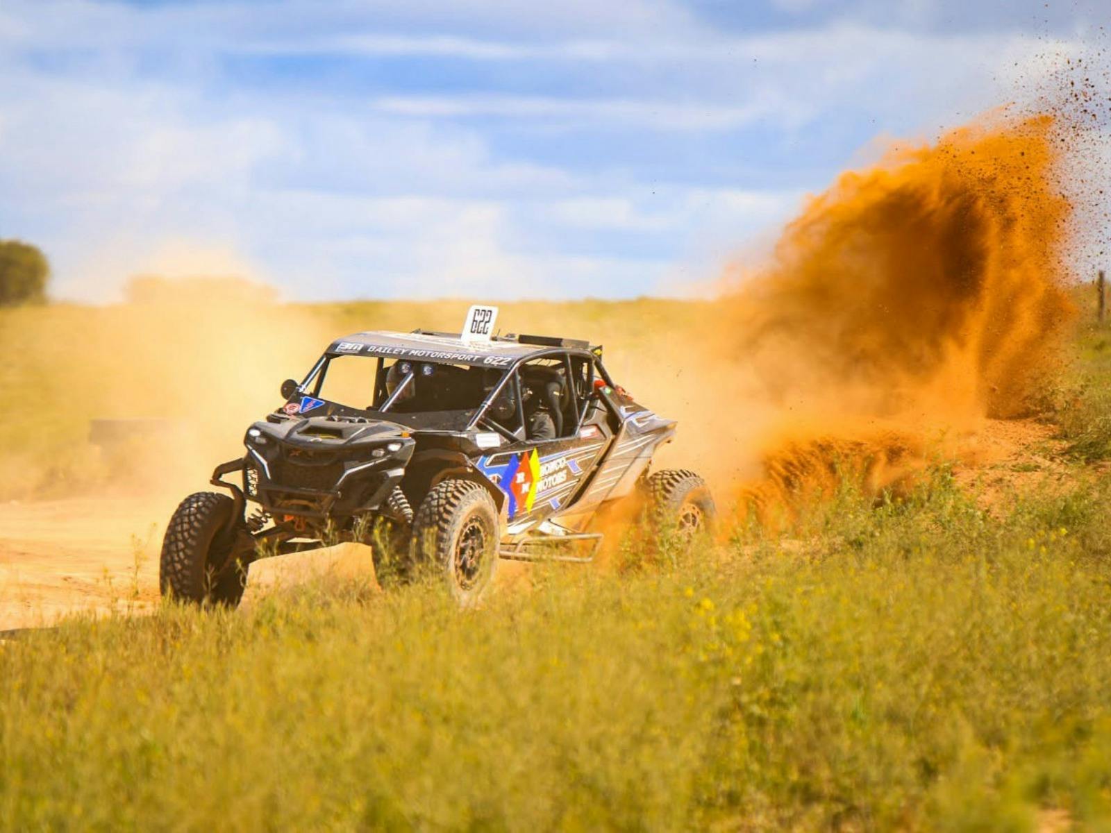 Off road side by side racing in red dust