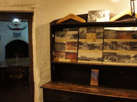 General view of interior of old homestead building, furnished in period pieces, and displays of hand-made interpretive  material.