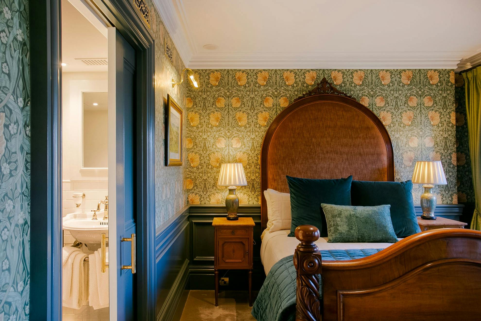 Luxury suite with Antique bed and William Morris inspired wallpaper.