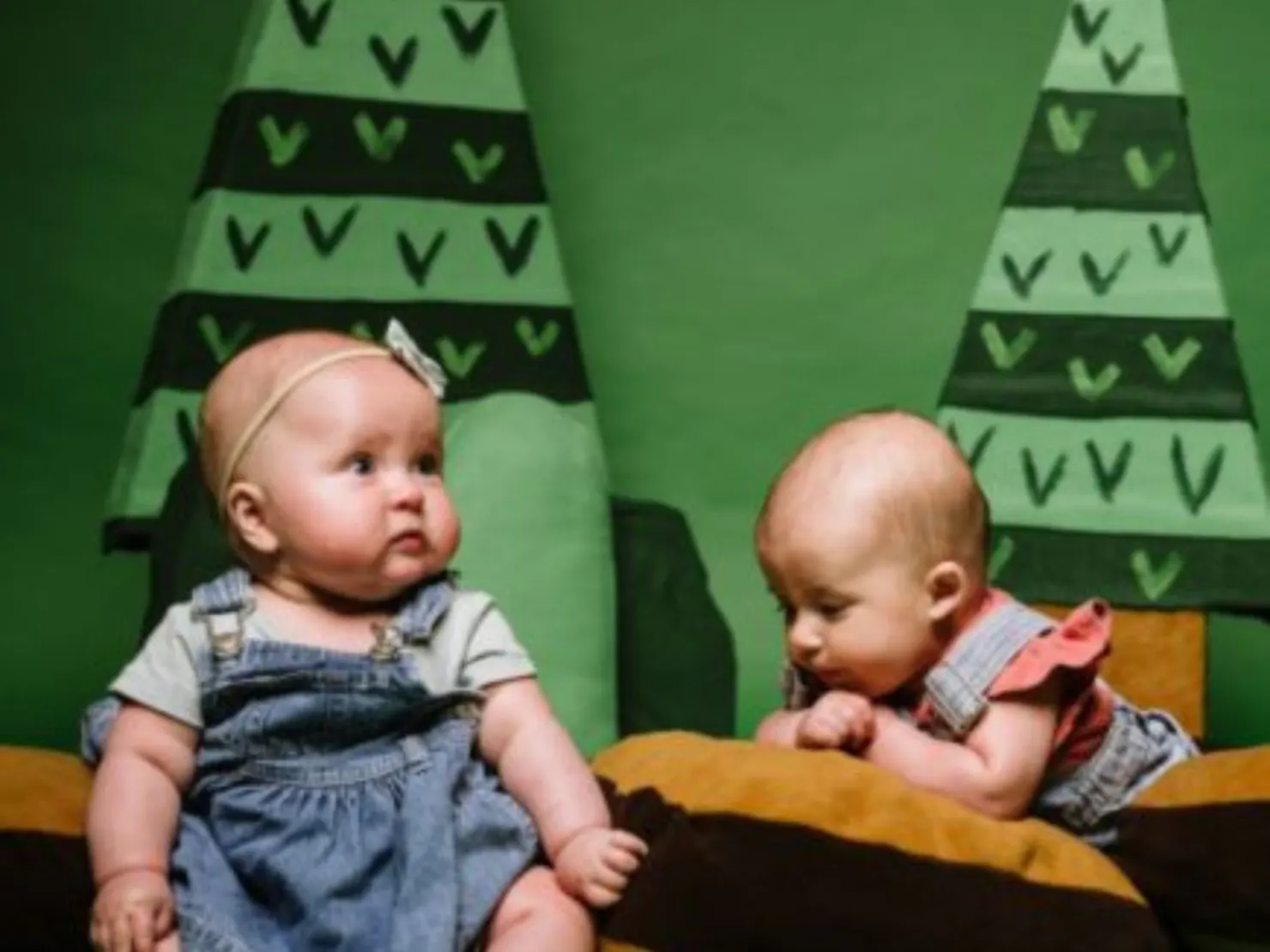two babies on cushions