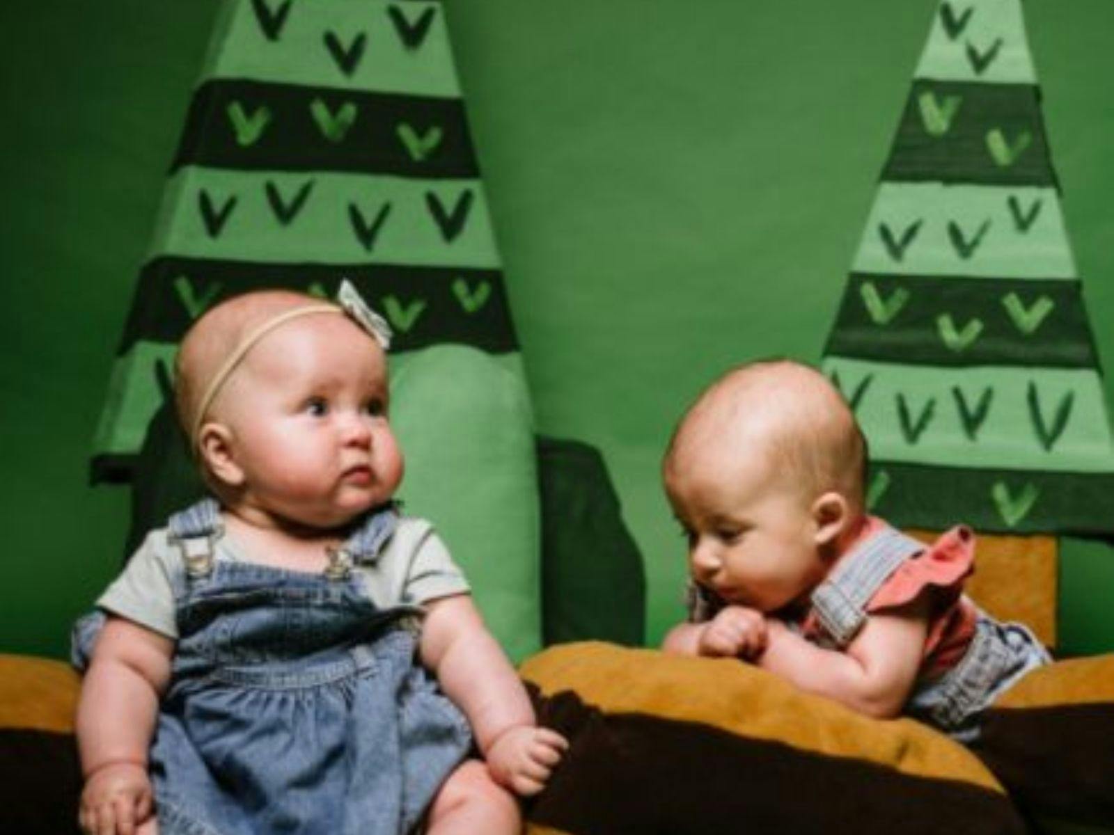 two babies on cushions two babies on cushions