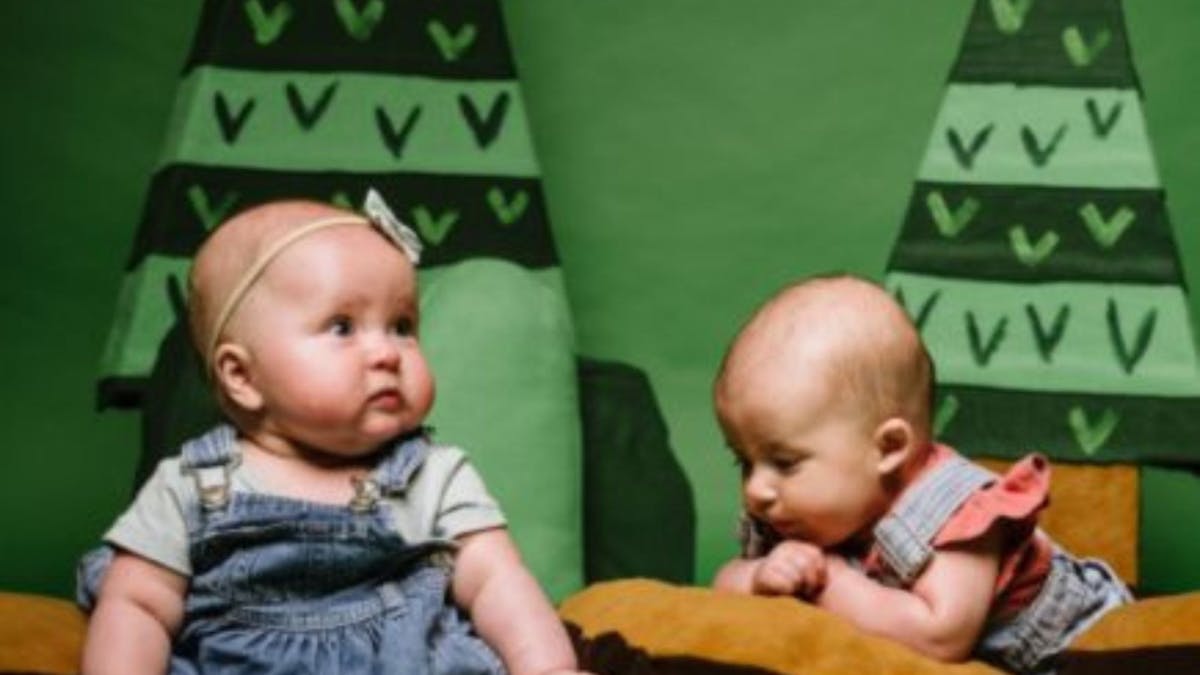 two babies on cushions