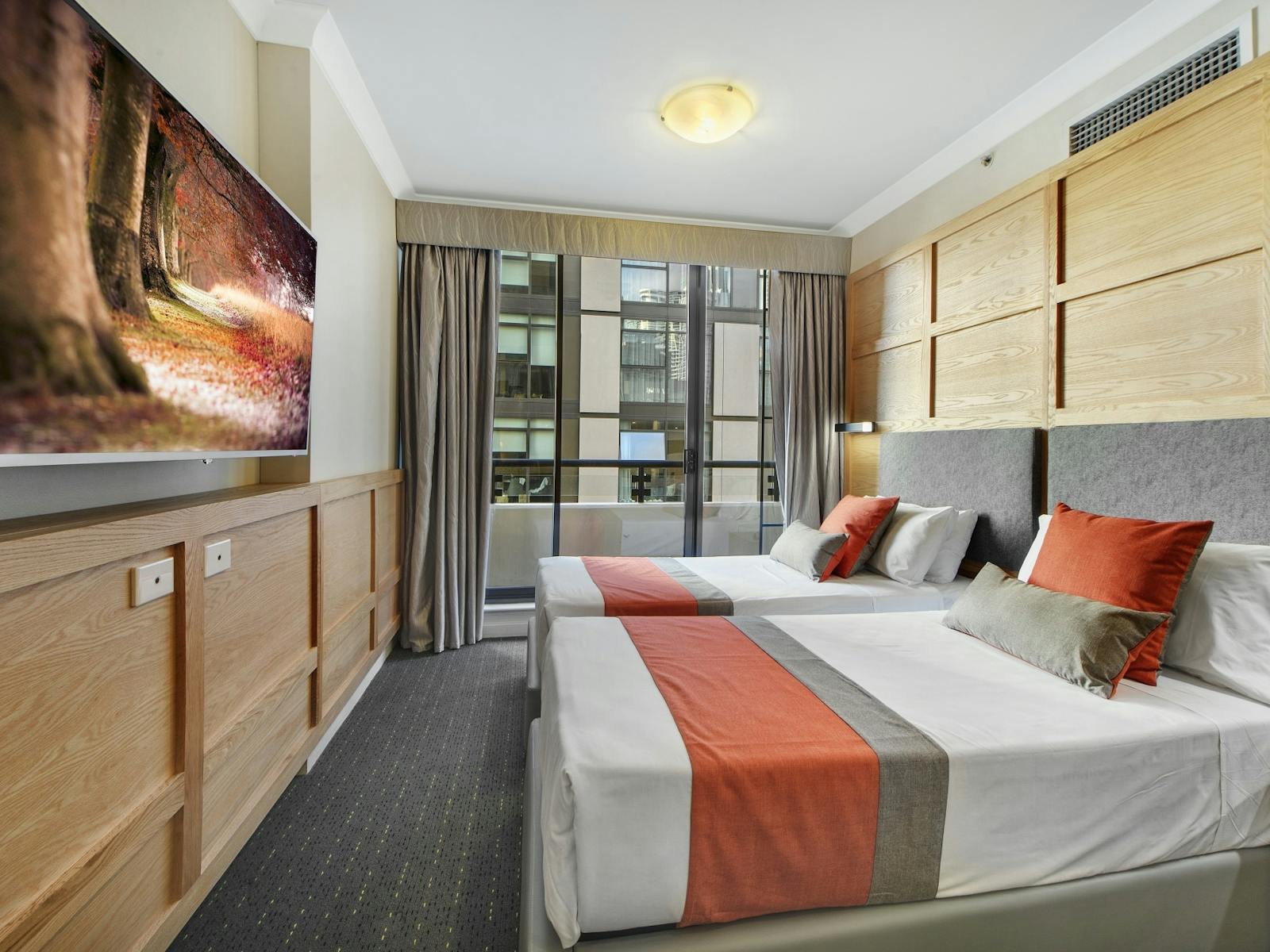 Two single beds in living area and a queen bed in the bedroom