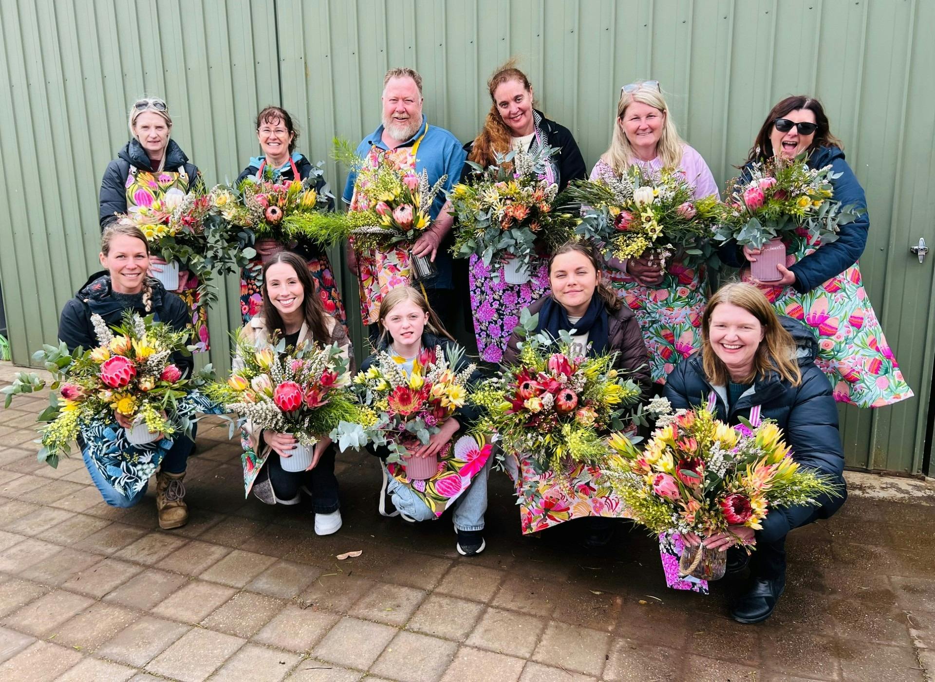 Workshop participants showcasing their unique bouquet creations.