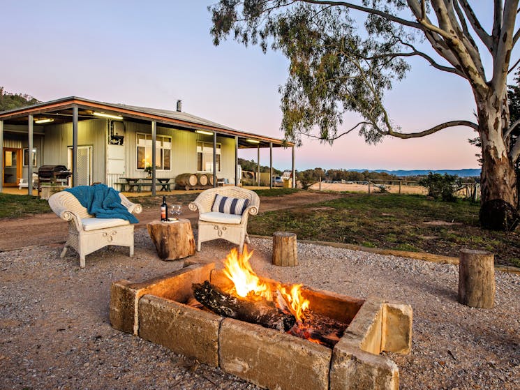 View across the firepit to the large guesthouse.