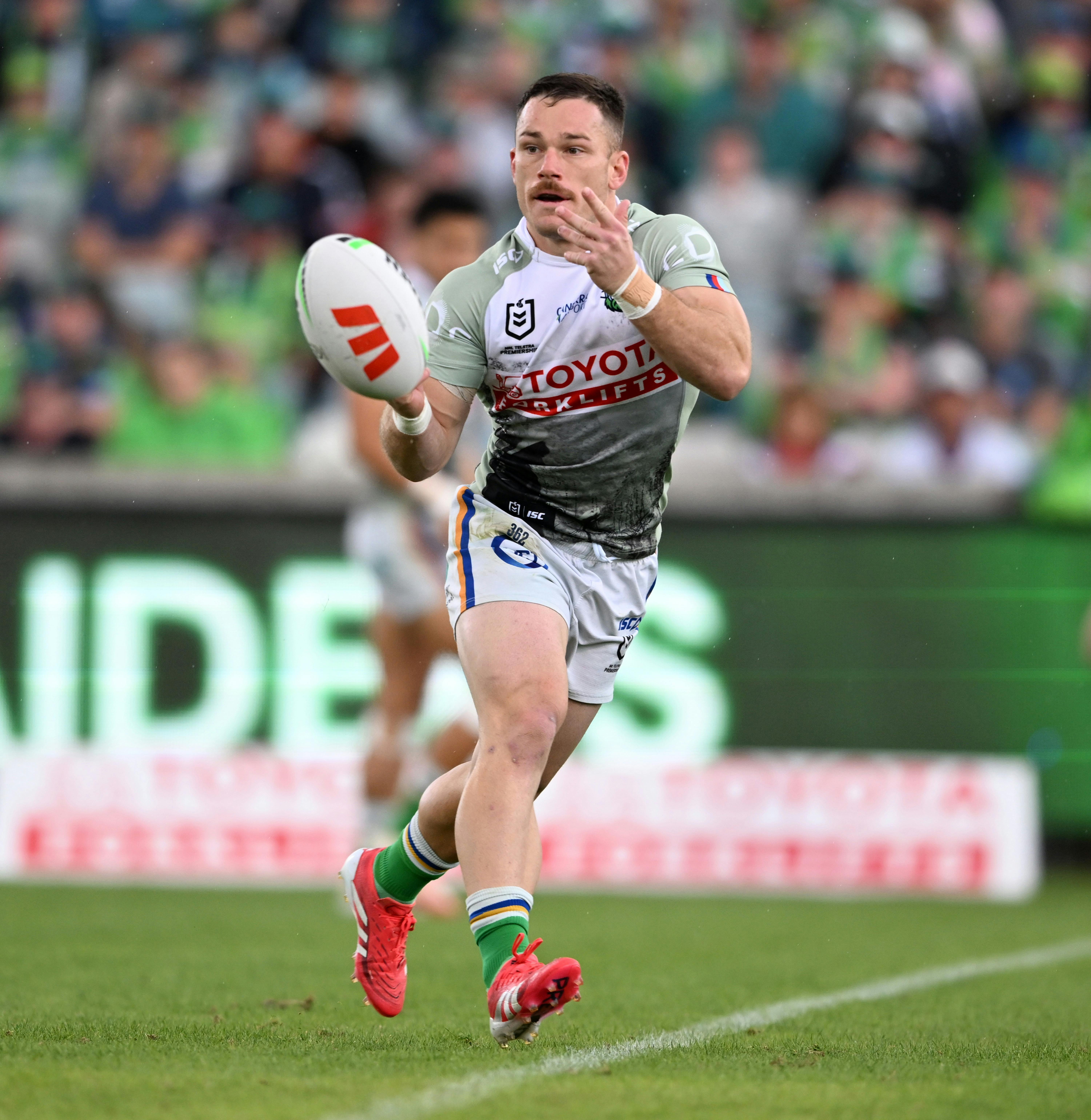 Canberra Raiders player Tom Starling passing the ball.