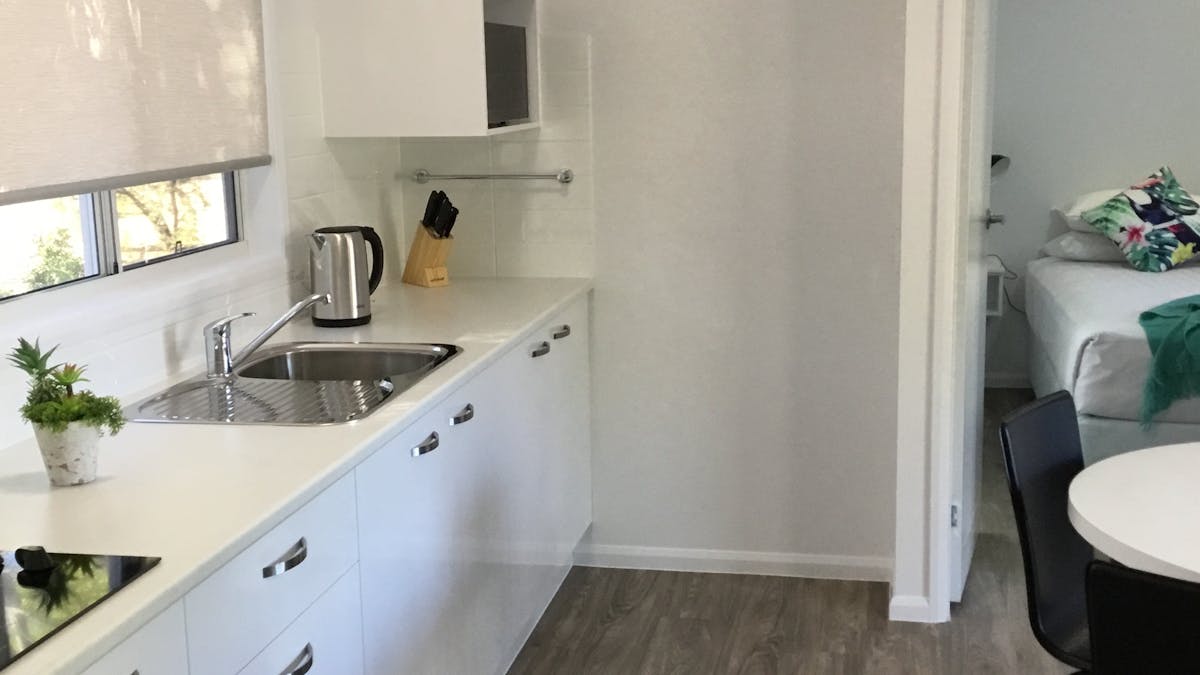 Modern design cabin with large kitchenette, full size refrigerator, queen bed + twin king bedroom.