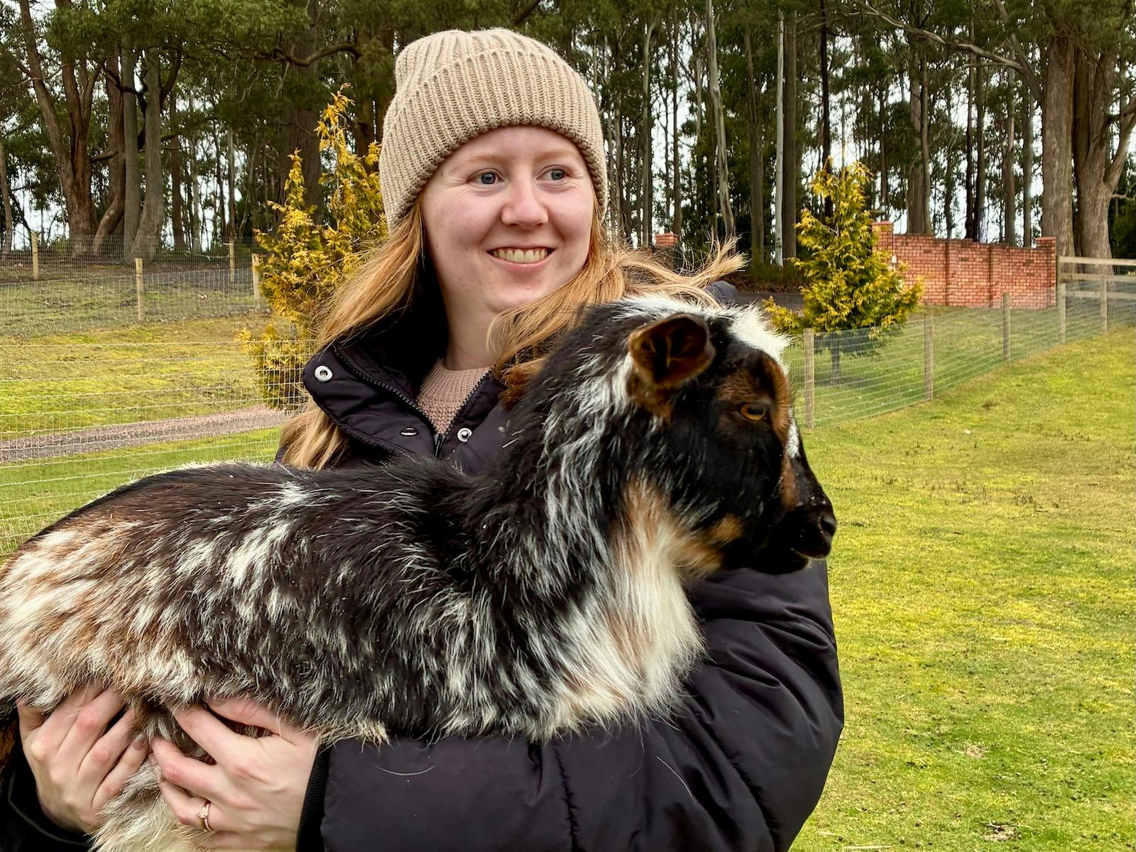 Lady holding a baby goat