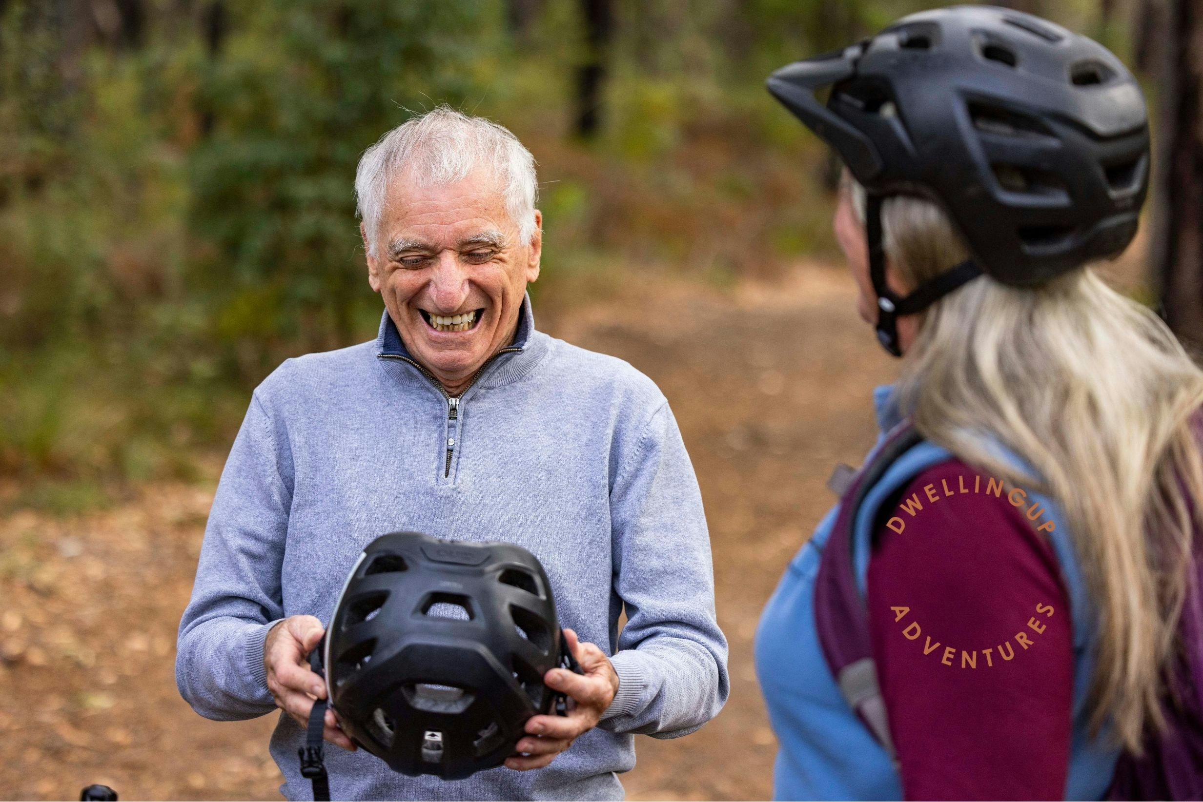 Man and women putting on helmet and laughing