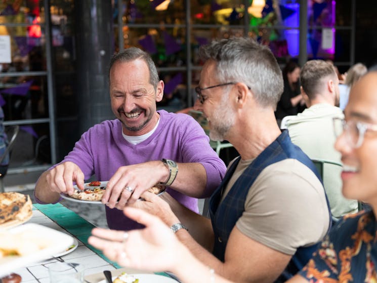 Couple enjoying food and drinks with friends at The Beresford, Surry Hills