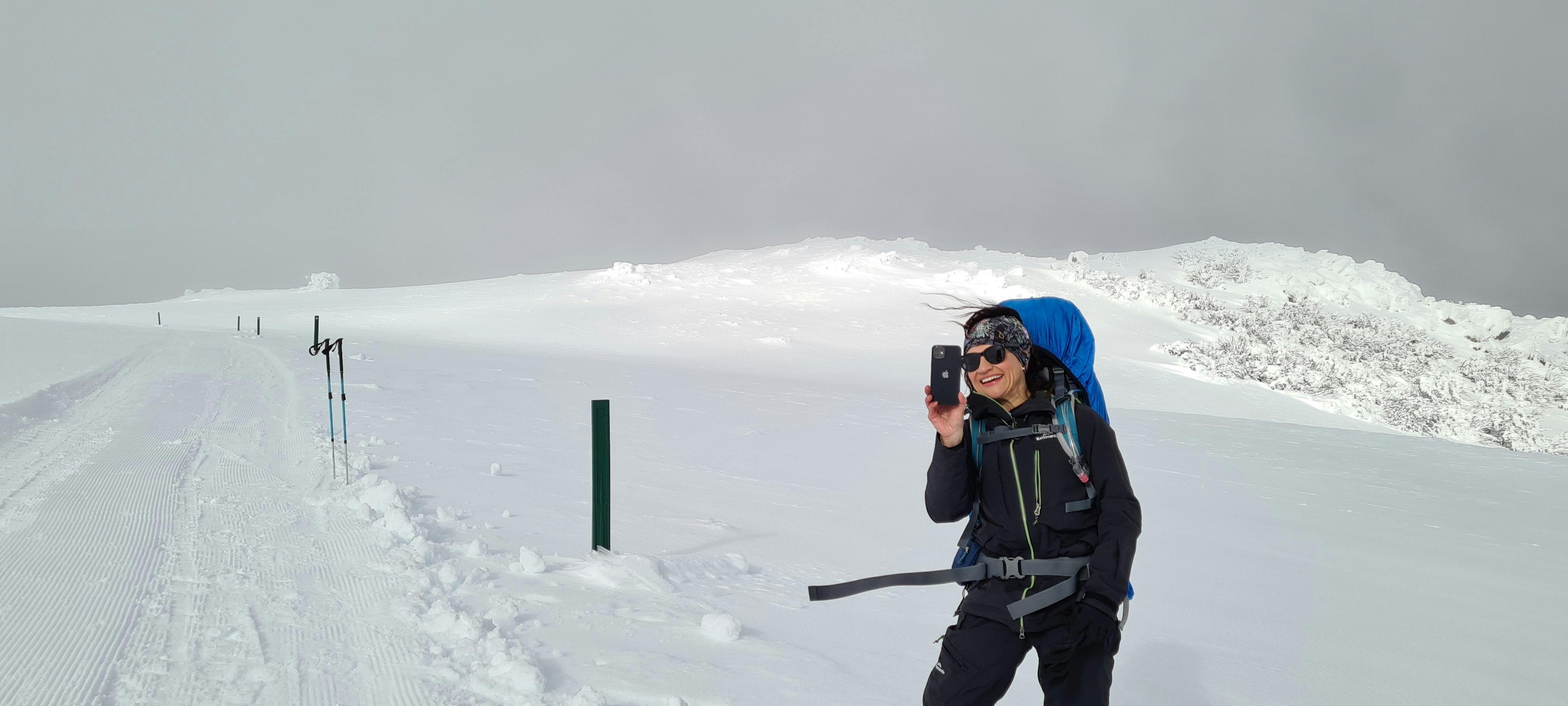 A client taking photos up above the tree line, not far from the summit.
