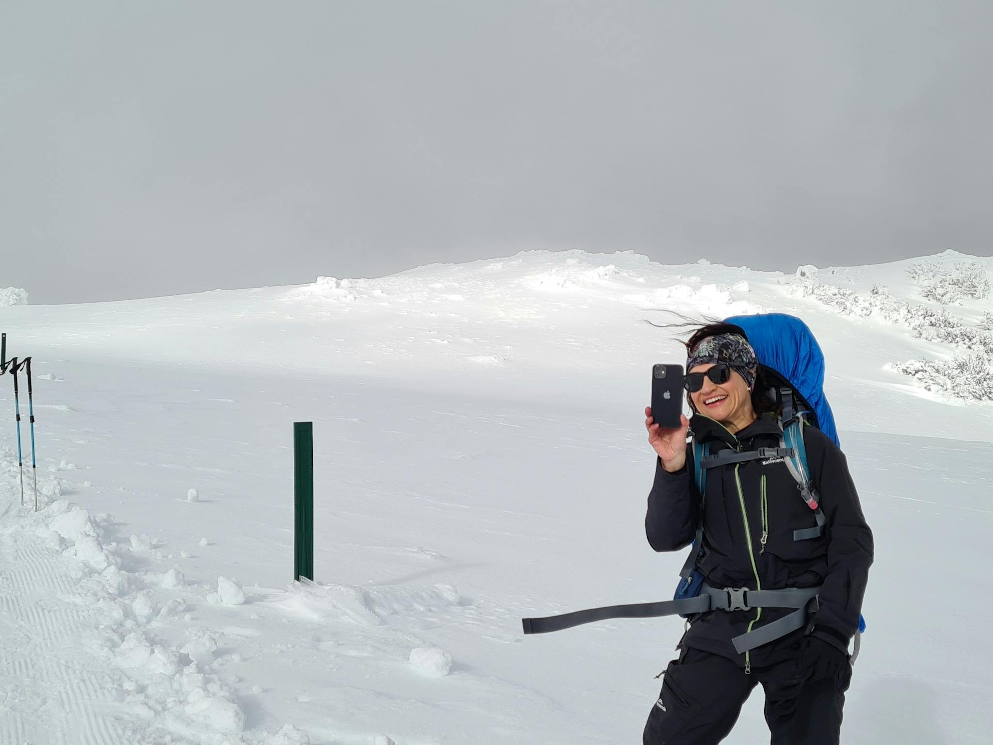 A client taking photos up above the tree line, not far from the summit.