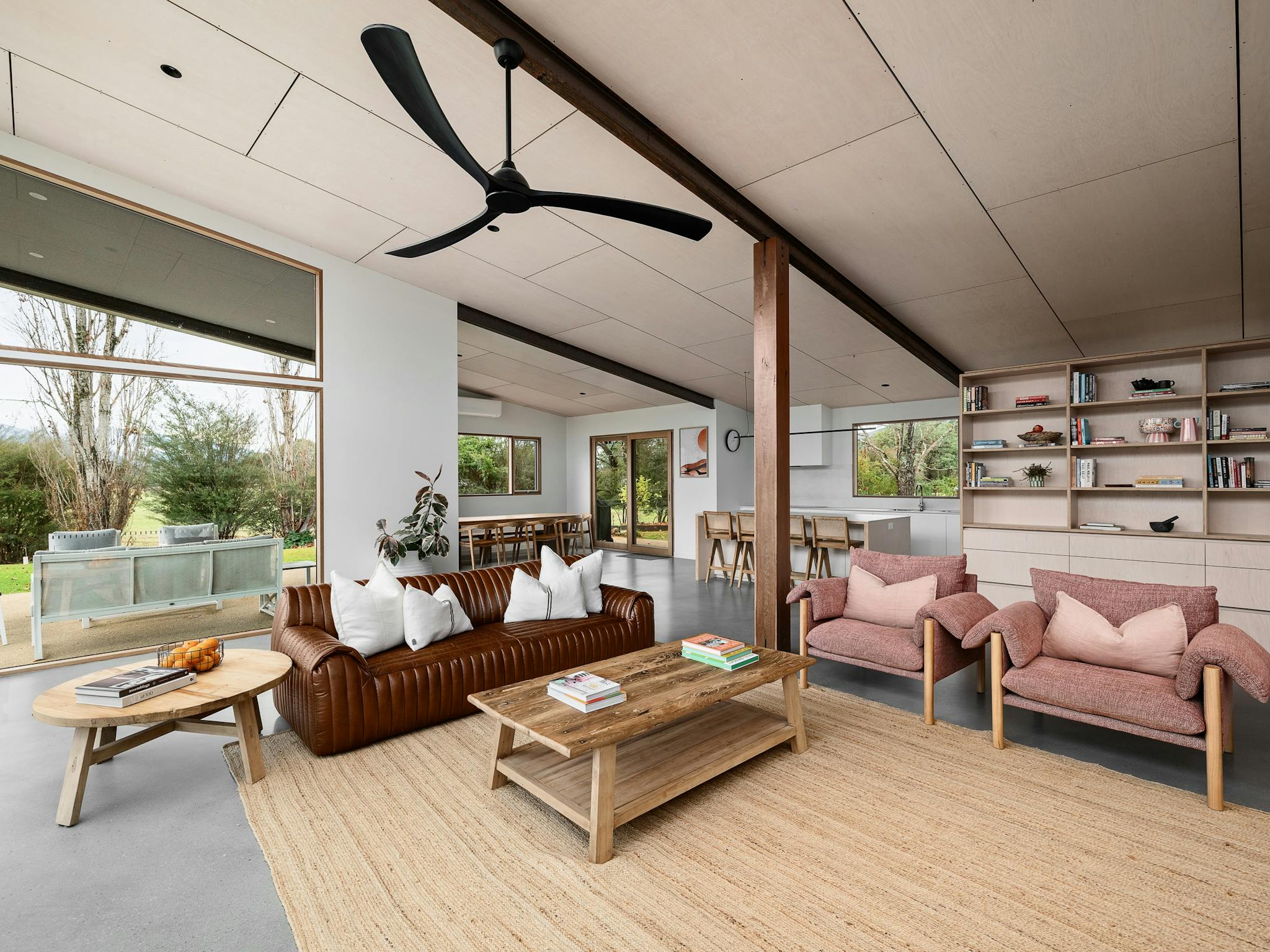 silver house,  living room area with couches, chairs, tea table and a ceiling fan