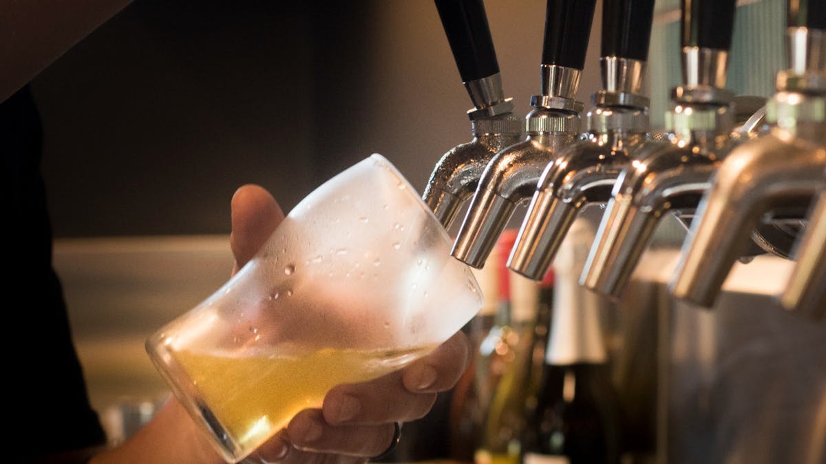 Pouring beer into a glass with precision