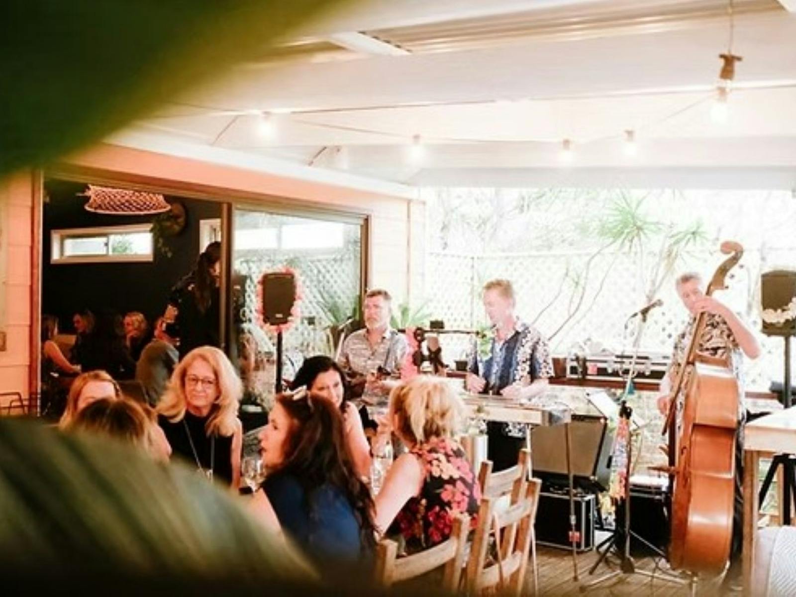 people dining and a band playing music in background