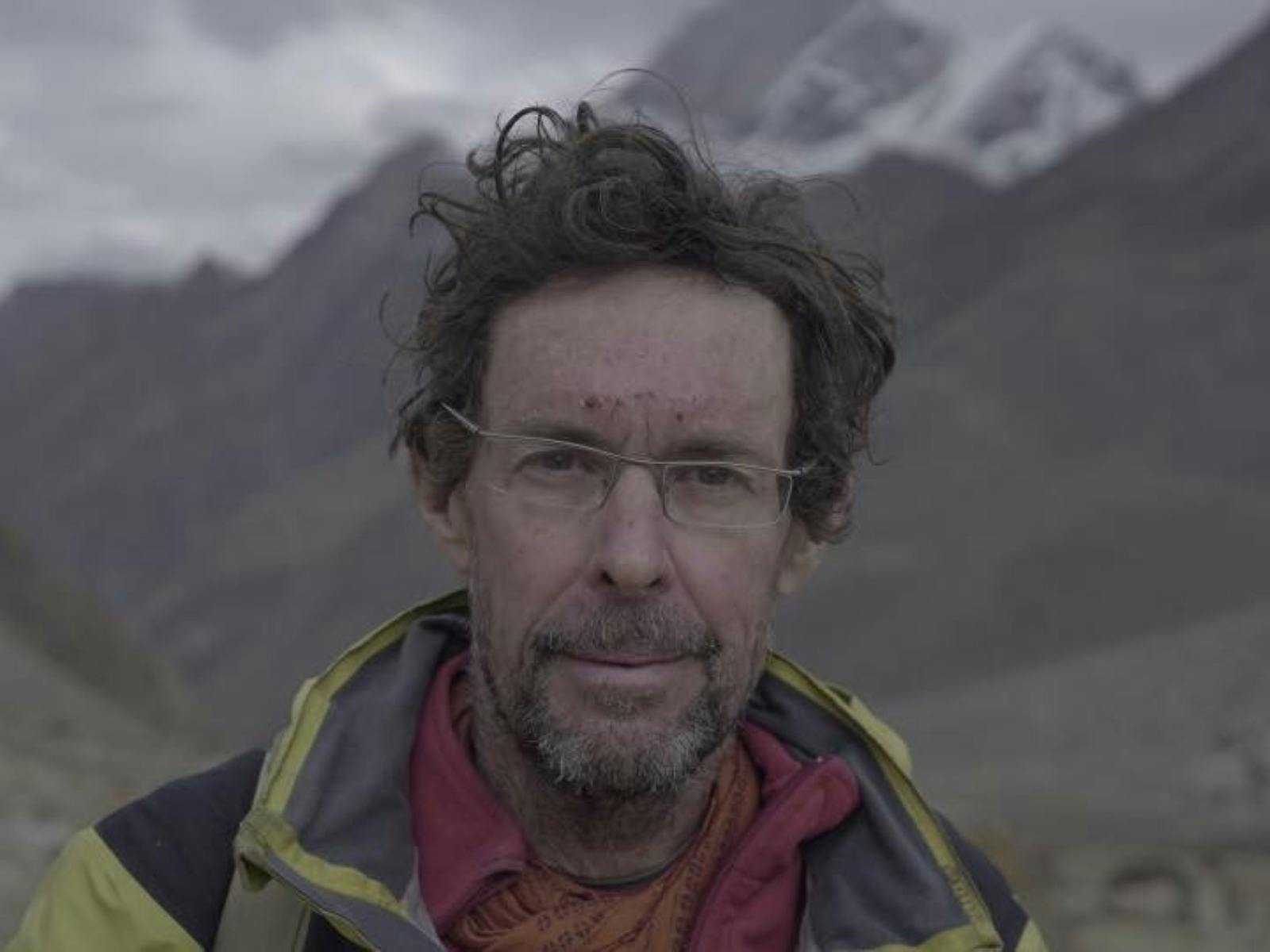 Man wearing glasses profile image with mountains in background