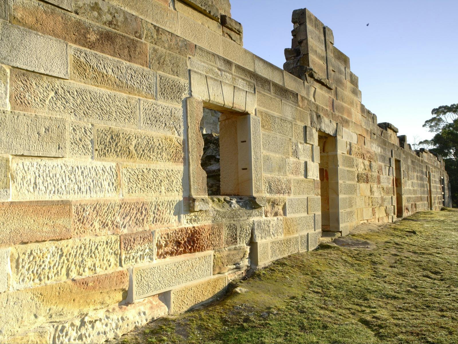 Detailed convict handmade sandstone outside wall of historic building