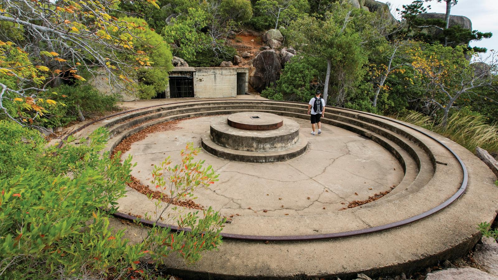 Man standing on remains of gun emplacement.
