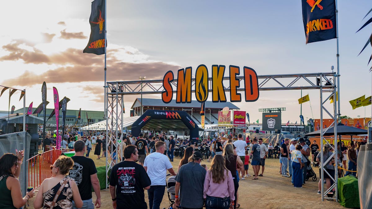 Smoked Festival sign with people walking underneath it