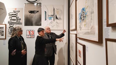 People exploring the Taglietti exhibition