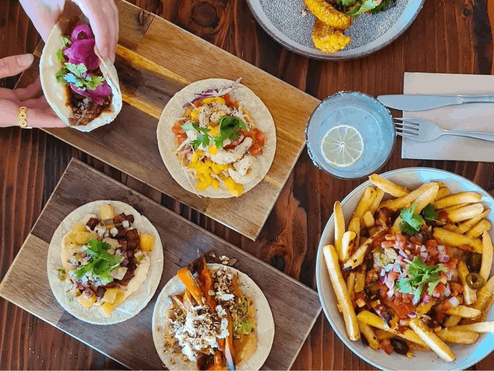Tablescape of tacos, chips and a cocktail
