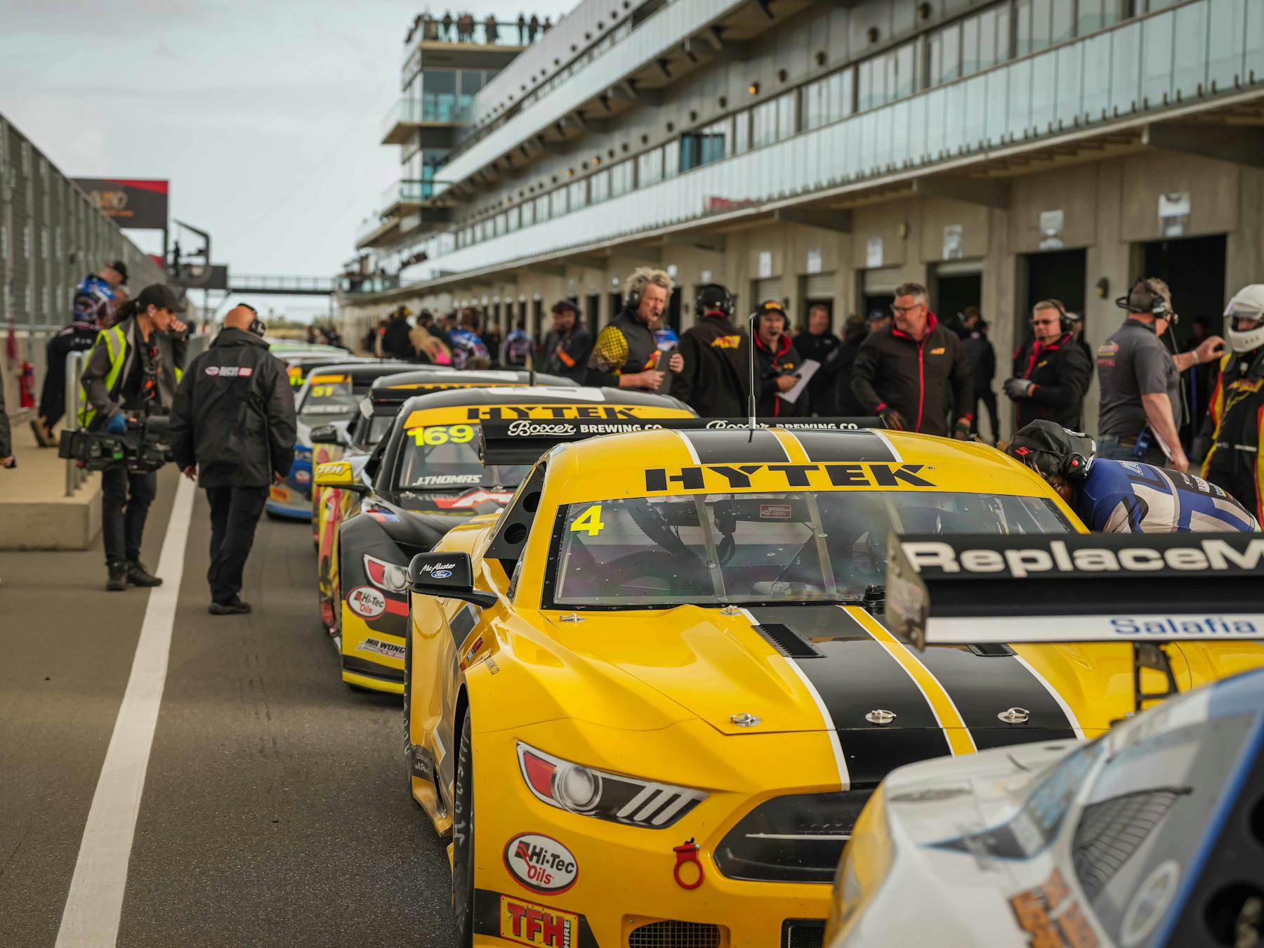 Cars lining up in pit lane