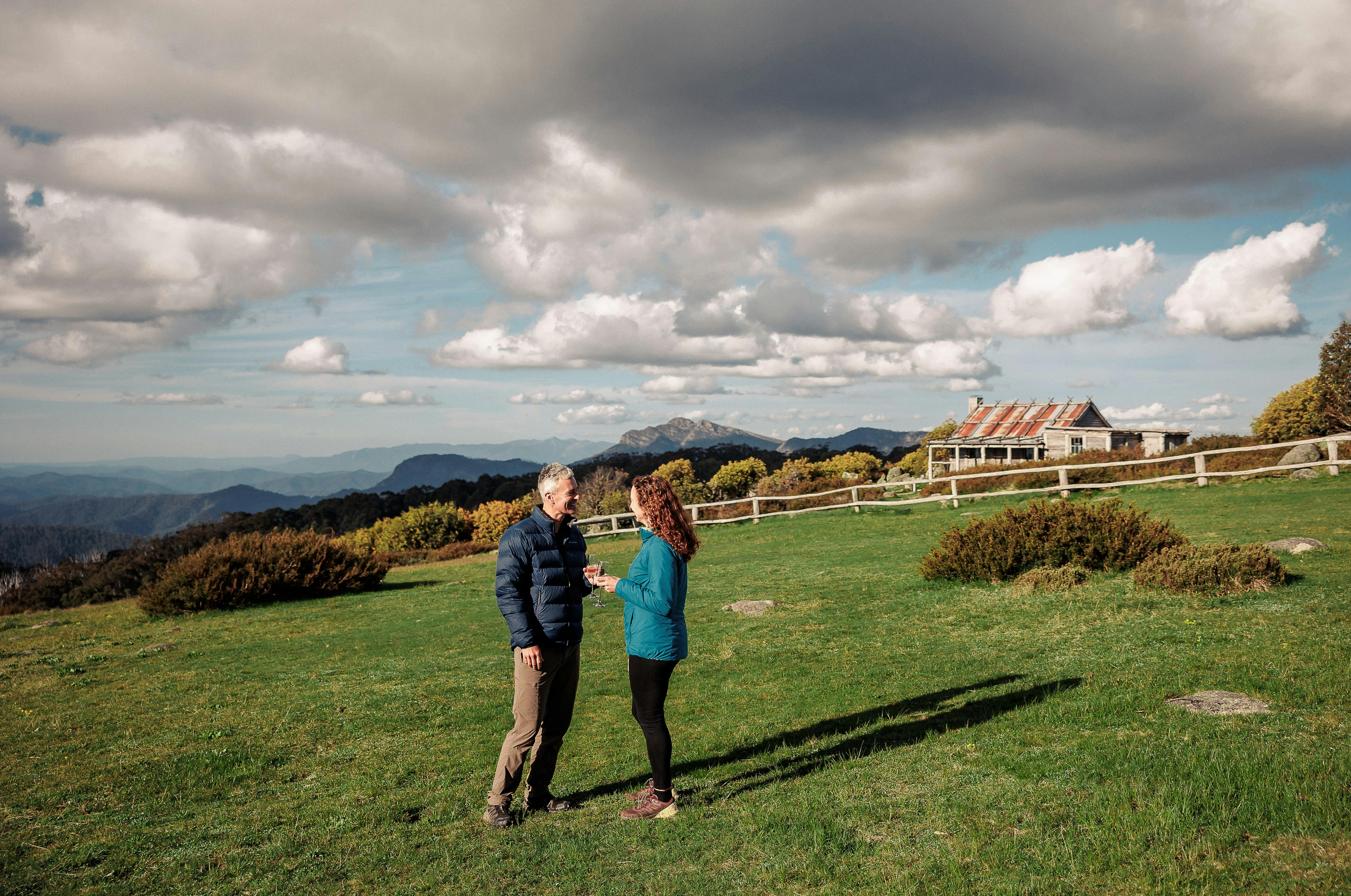 A couple enjoying a beverage and some private time in the surrounds of Craig's Hut.