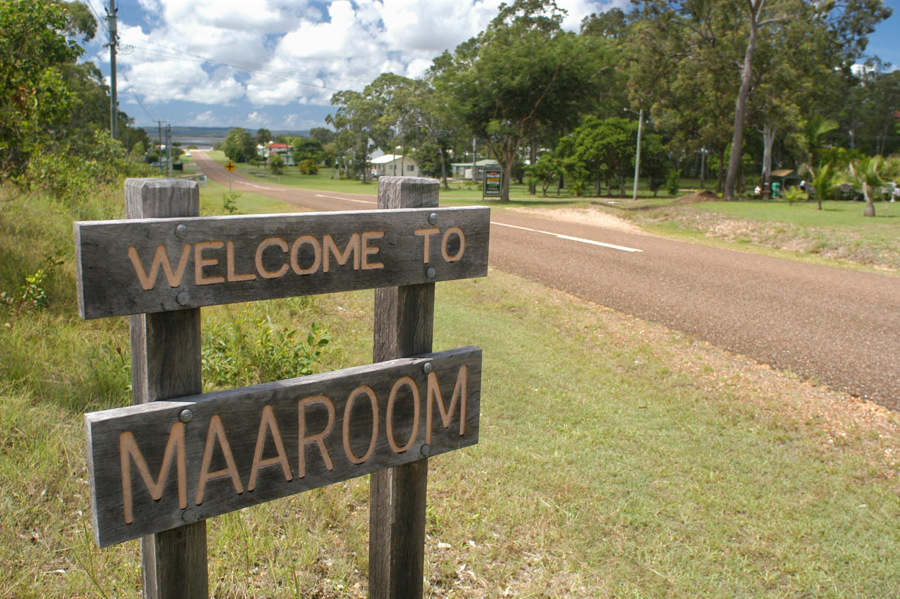 photo showing sign saying Welcome to Maaroom with hamlet in background