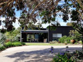 Exterior view of Harolds on the Hill showing landscaped gardens, lawn area and sheltered outdoor ent