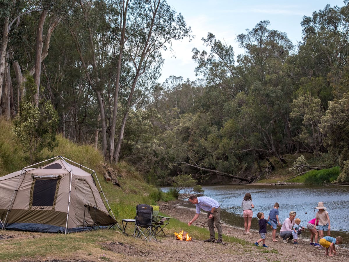 A family camping with a tent beside the river at Bengalla Reserve