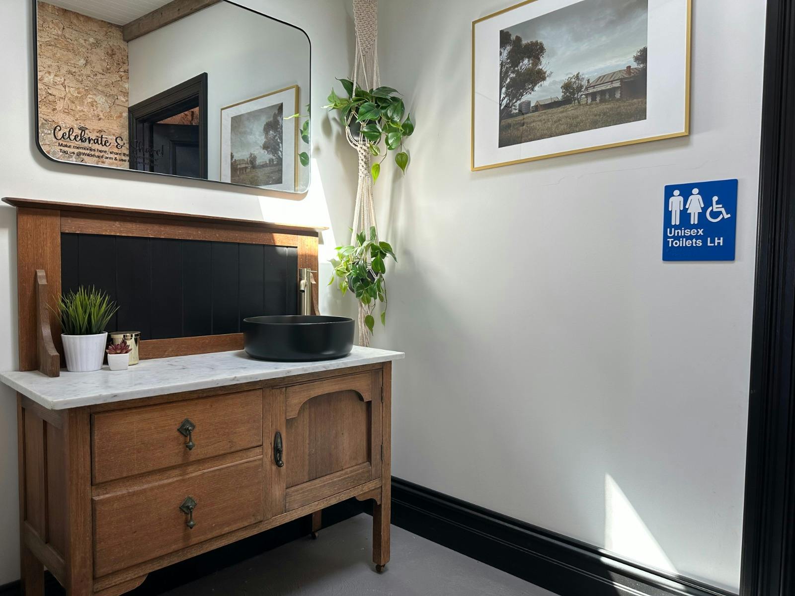 Vanity area with antique marble washstand, basin, and skylight in barn lean-to at Wildman Farm.