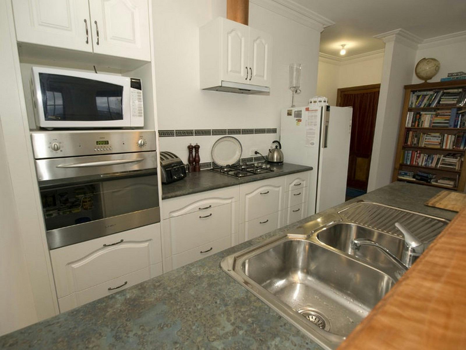 kitchen. open plan, induction hotplate, microwave, wall oven, small oven, pots,pans toaster, kettle