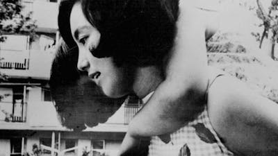 Black and white image of a woman holding a child