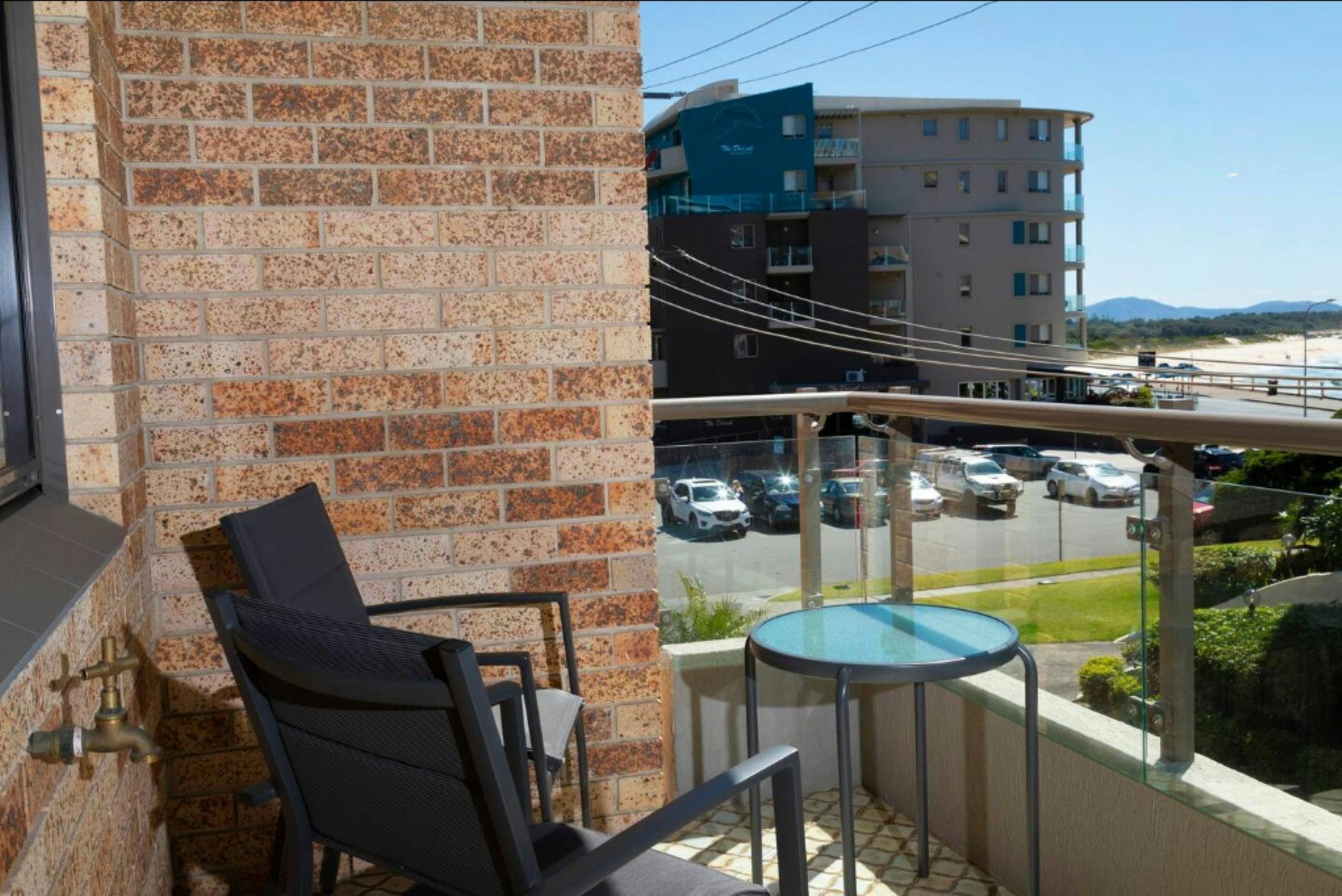 Balcony with 2 seater setting and beach glimpses
