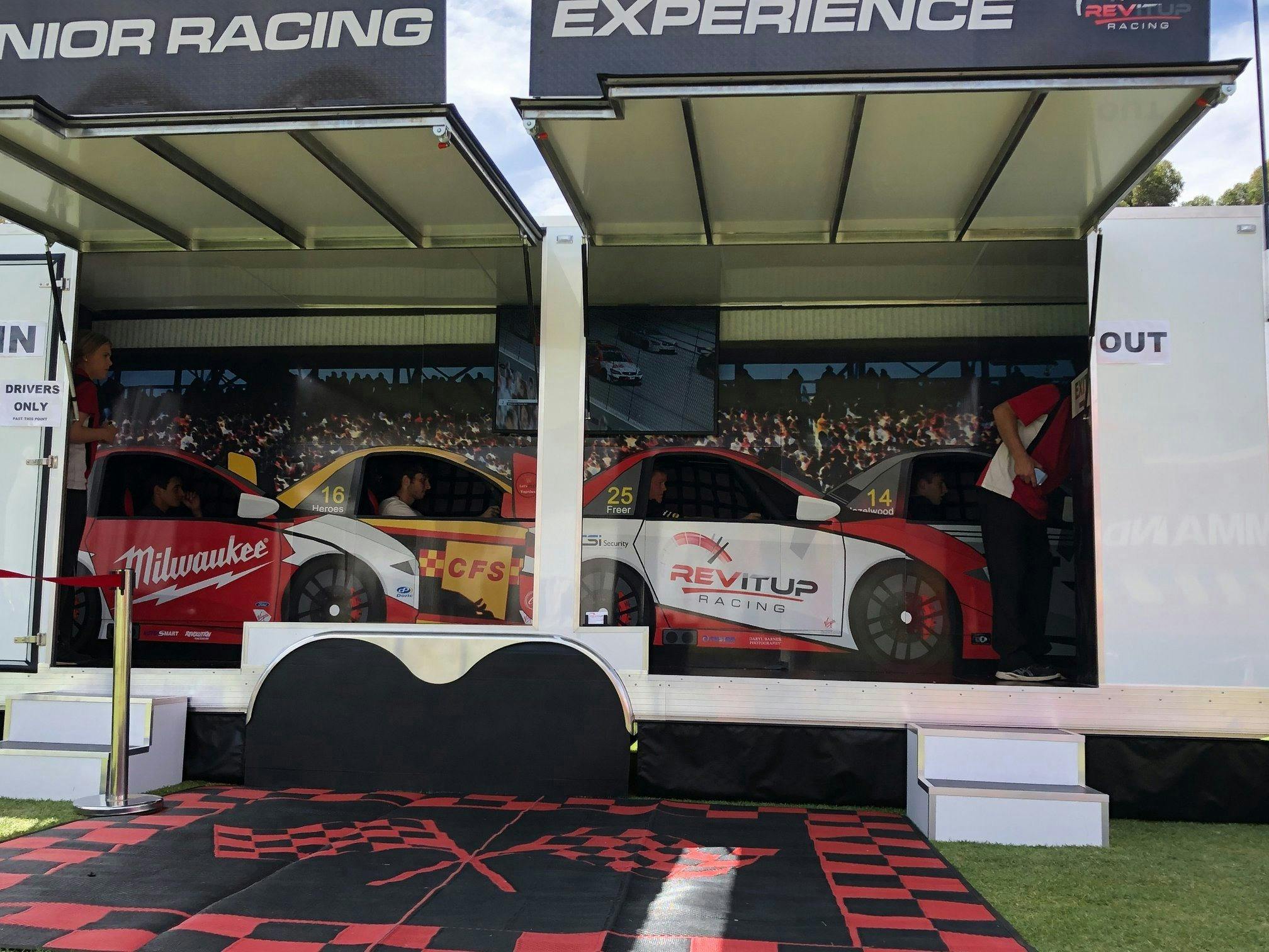 Racing simulator inside a large trailer set up in a grassed park