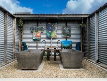 Each Bathhouse is constructed from recycled materials and features 2 handcrafted-bathtubs