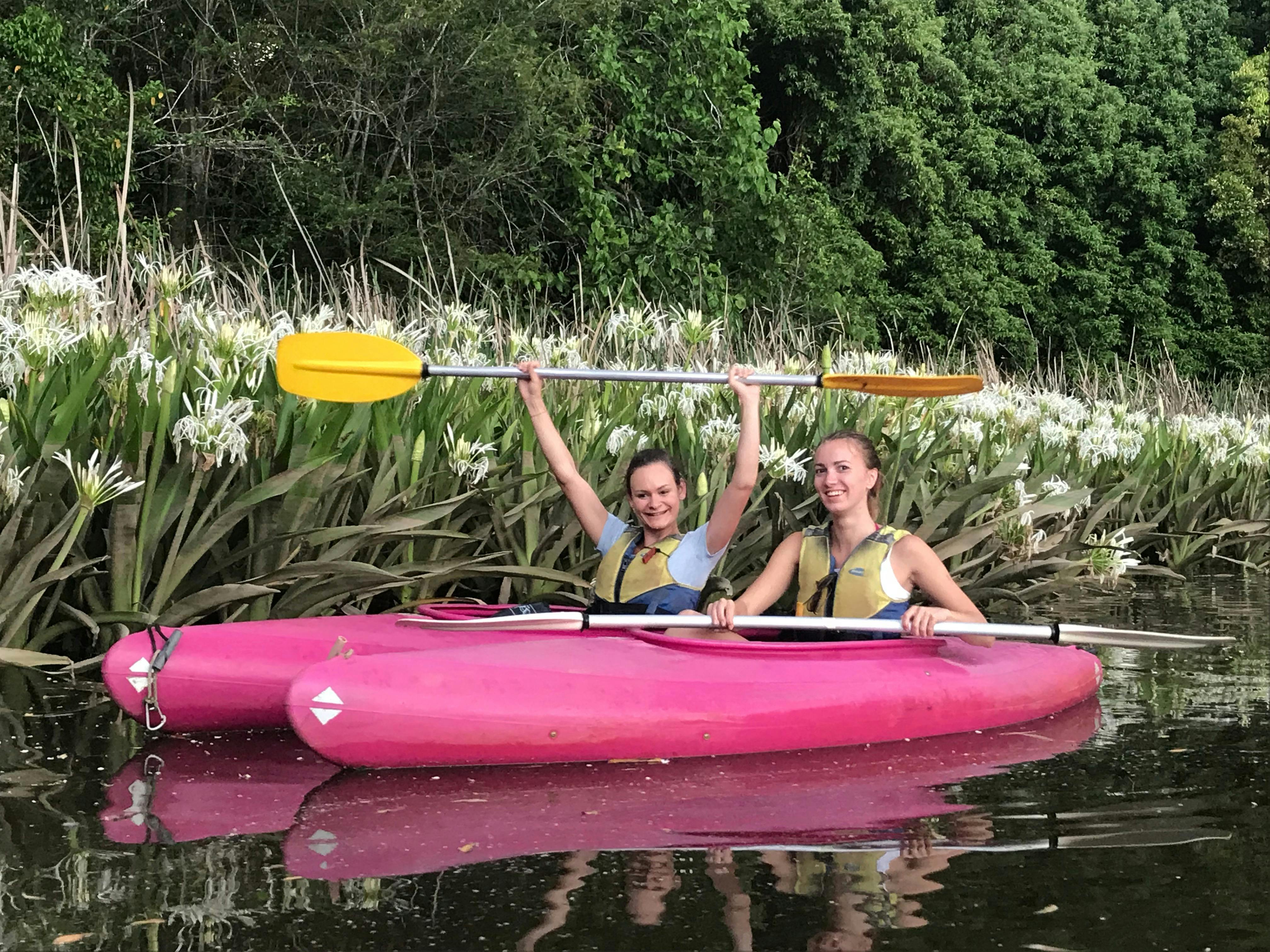 2 best friends paddling through the fragrant November lillies with Bellingen Canoe Adventures
