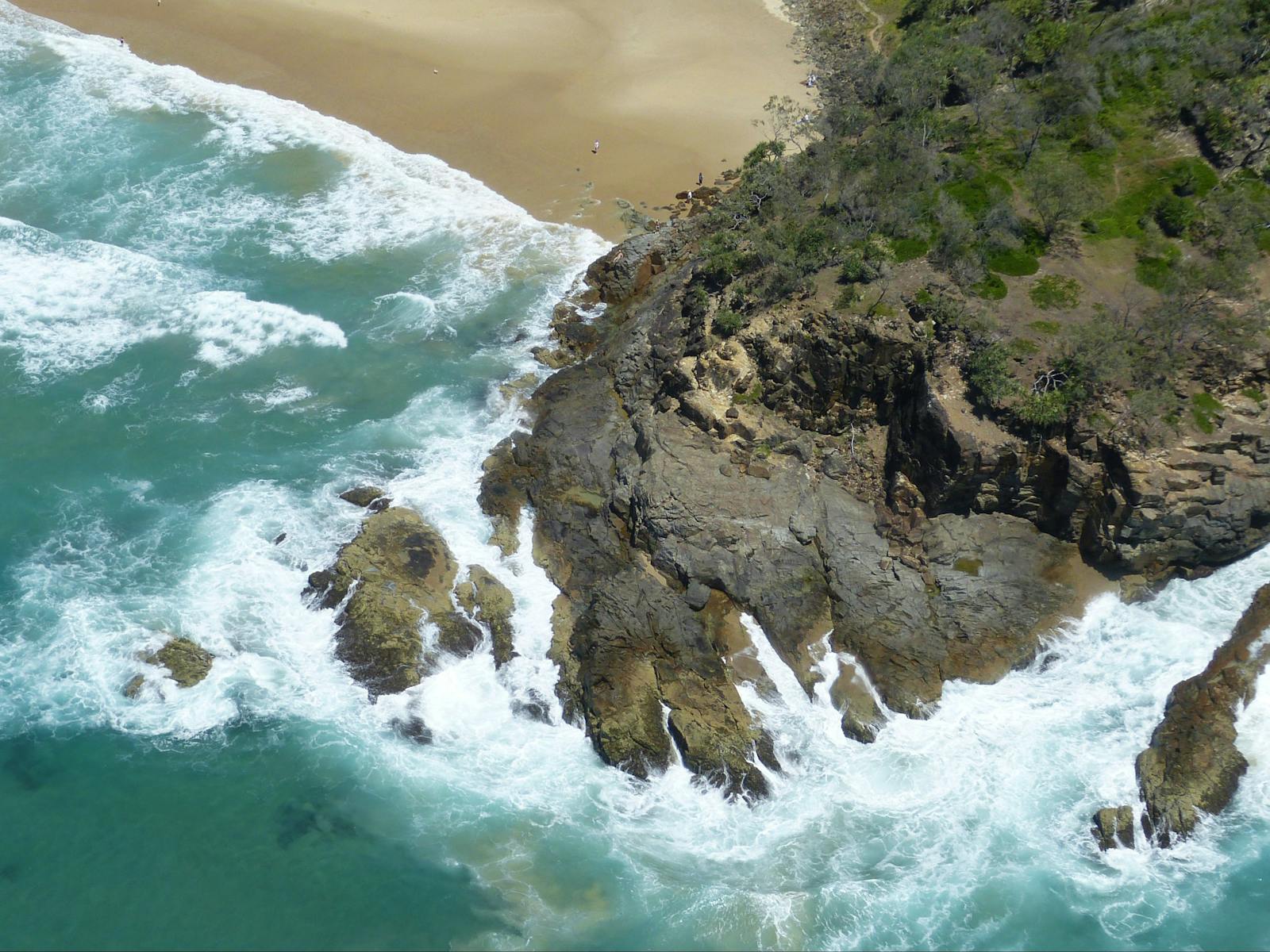Surf at rocks on Noosa Headland near Sunshine Beach from Wilga 80 seaplane