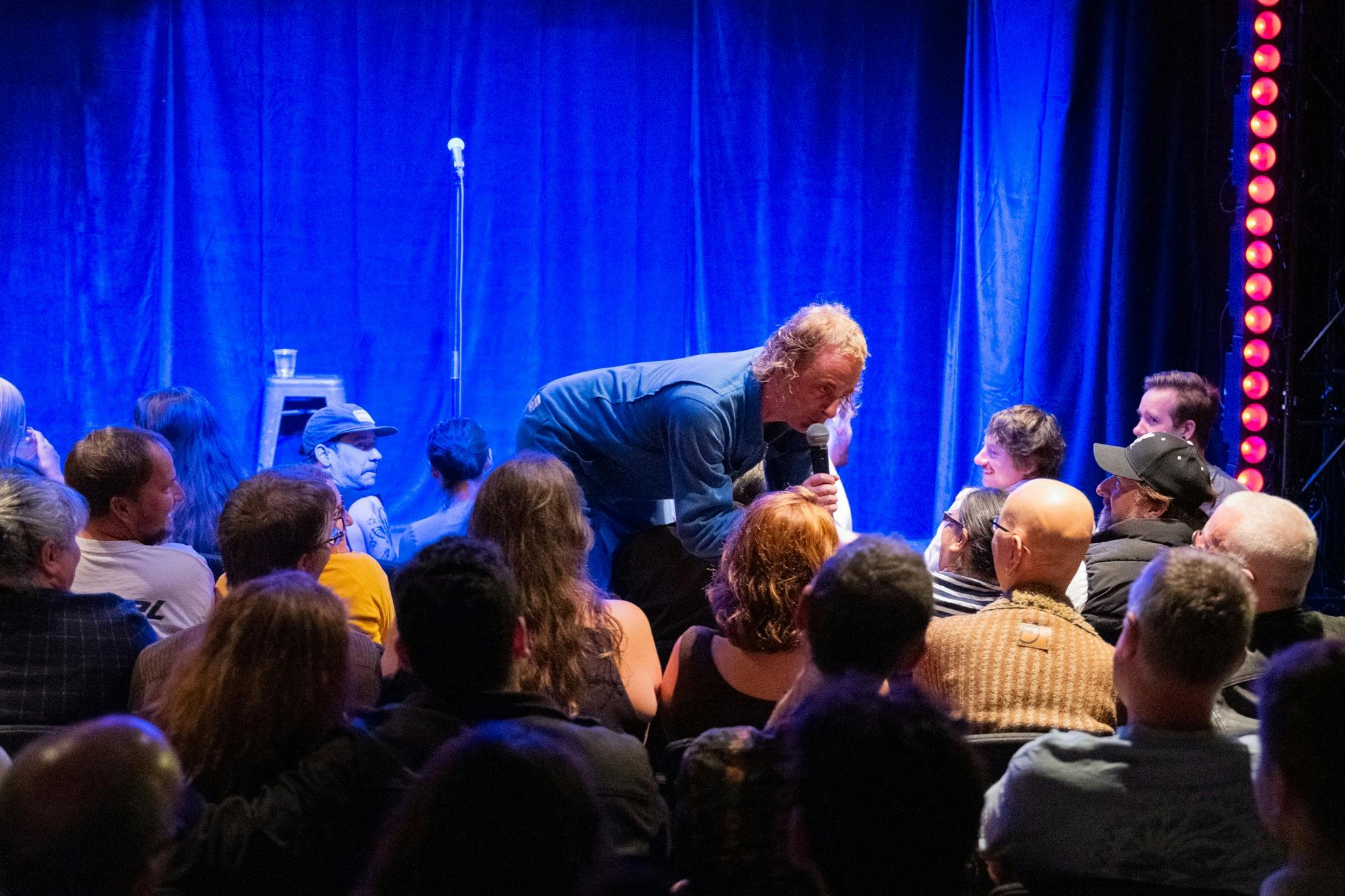 Live comedy performance taking place at The Comedy Store theatre.