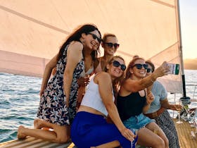 Group of girls taking a selfie on the bow of Pilgrim