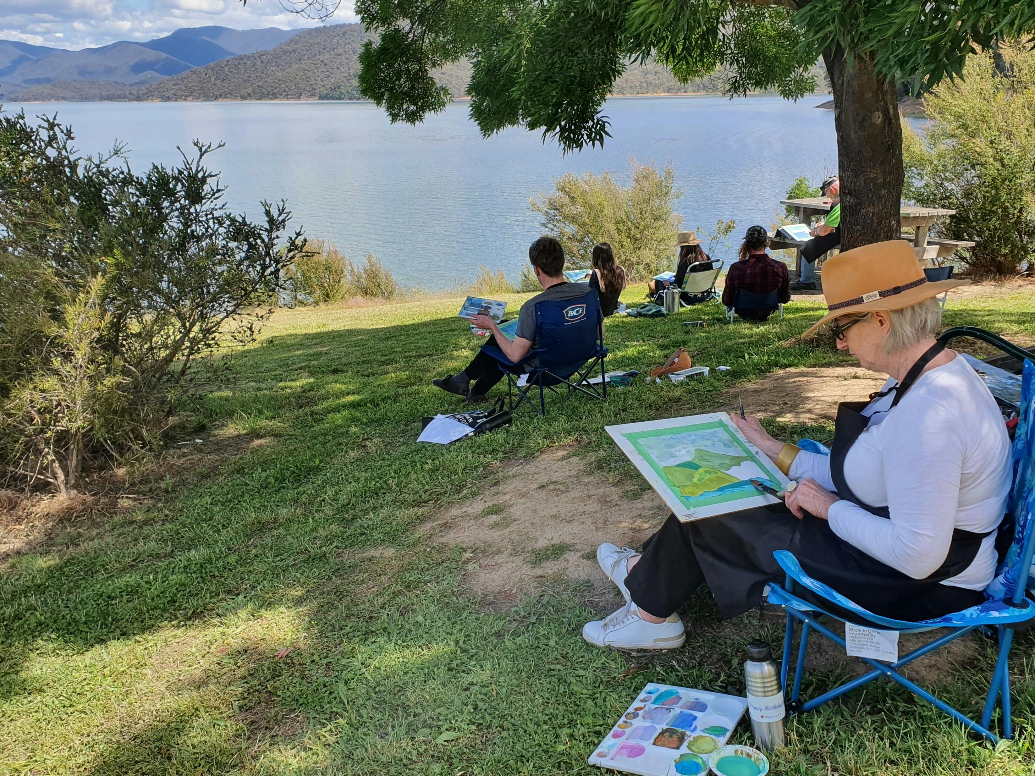 Artists paint the view of Lake Eildon in Wendy Jagger Studio workshop.
