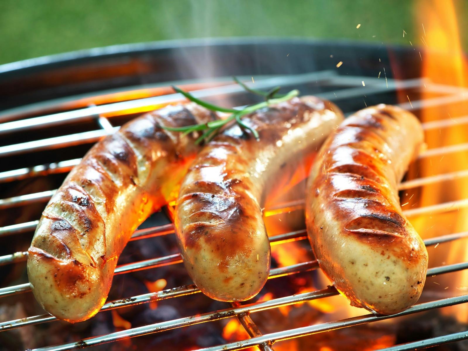 three sausages on a bbq
