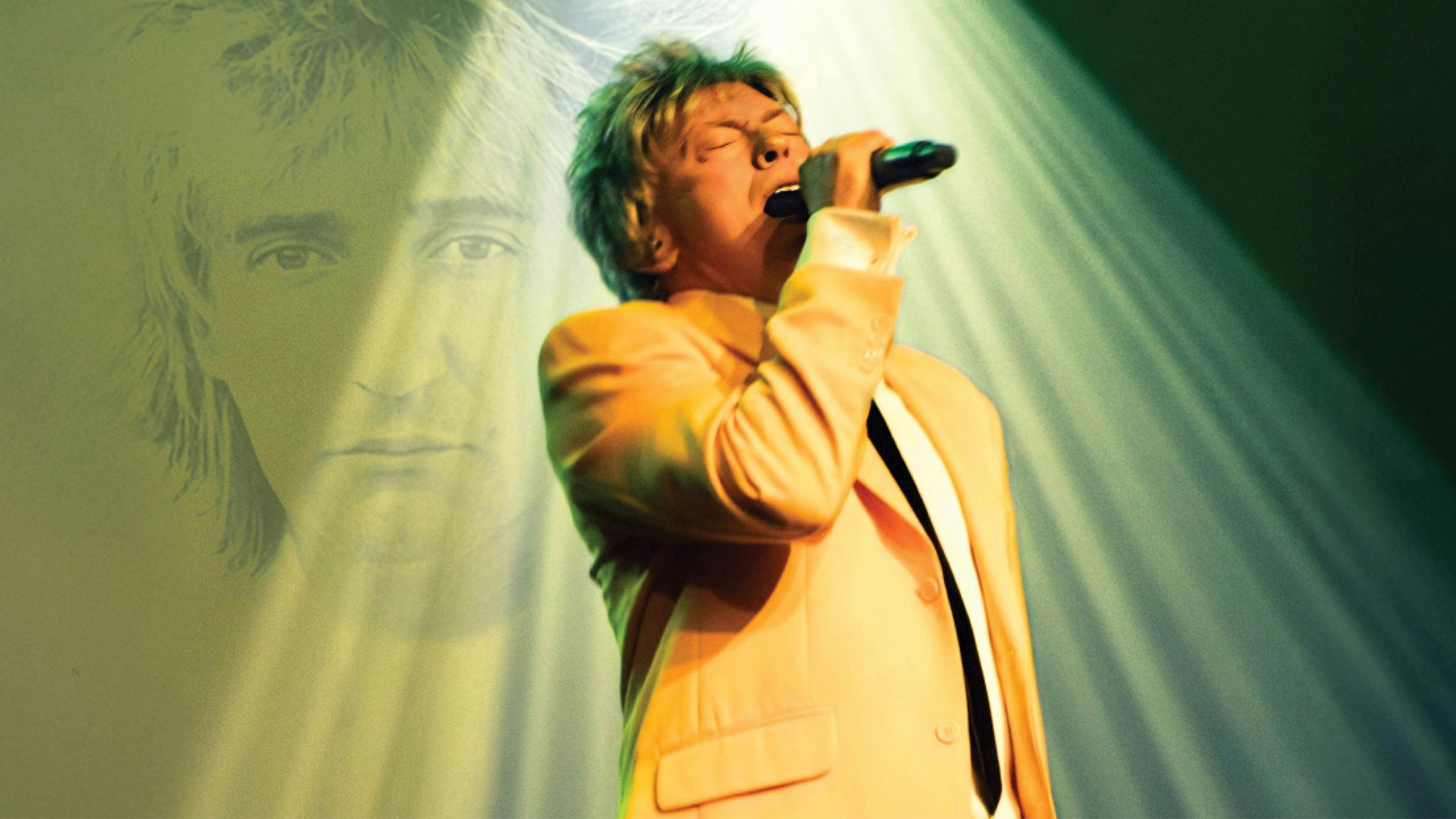 Shaun J. Marshall as Rod Stewart performing on stage.