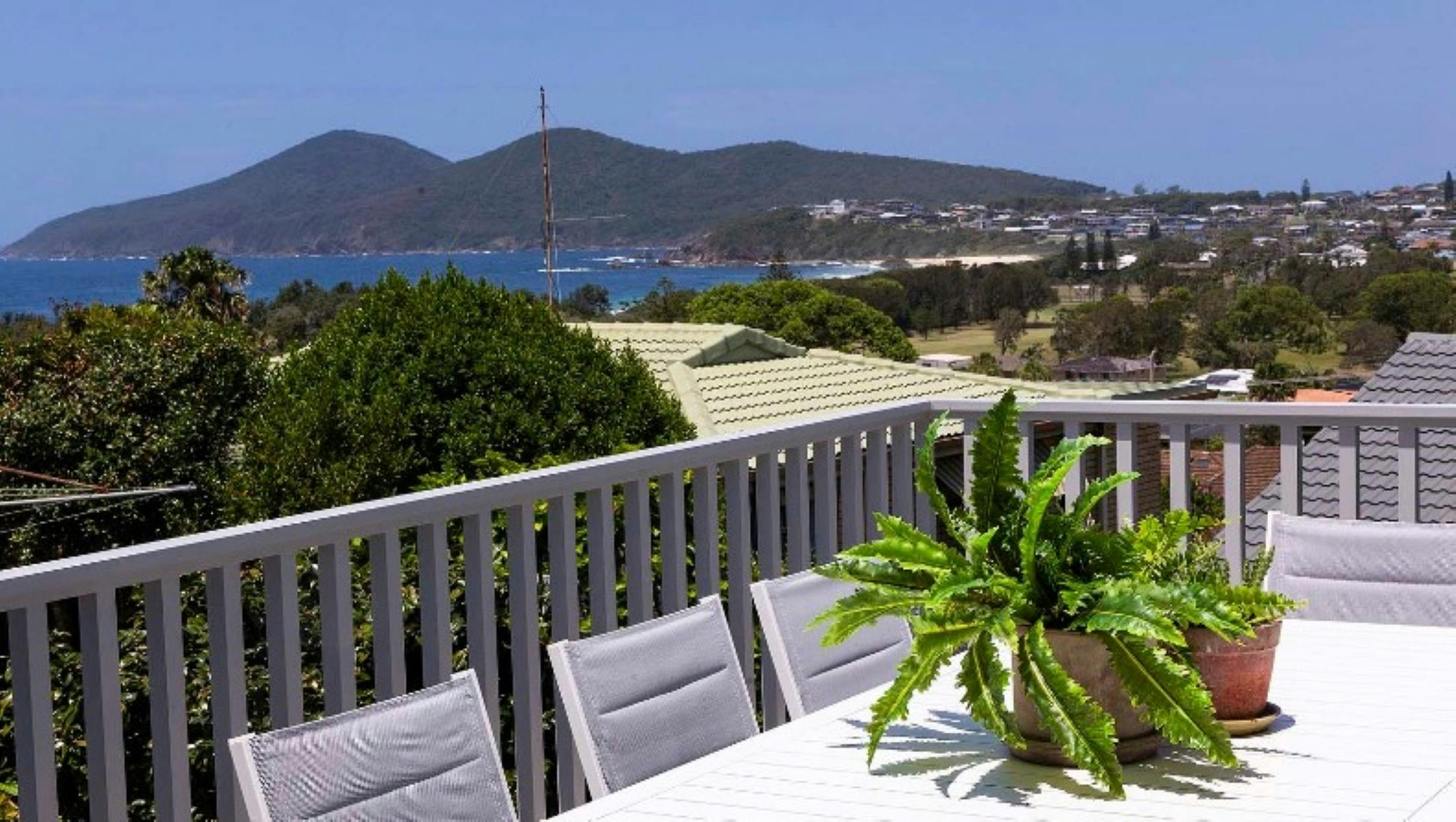 Balcony with dining setting and ocean views