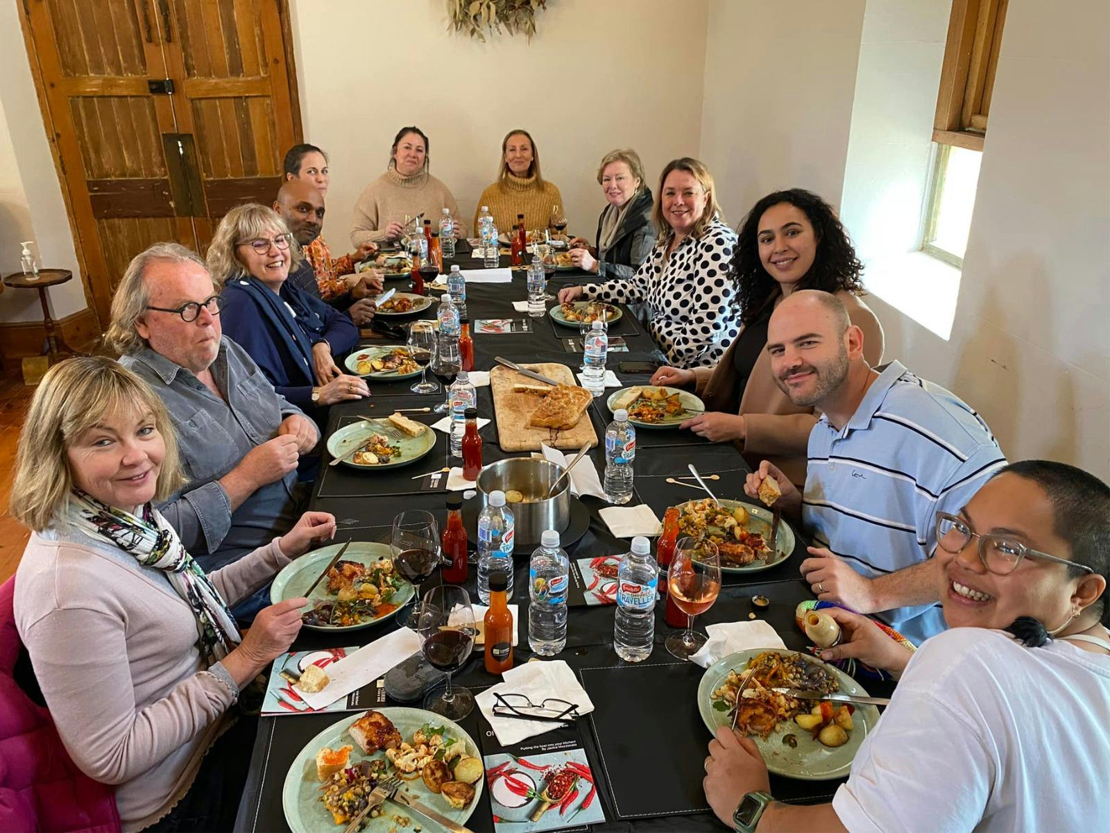 a group enjoying lunch after doing a Chilli cooking class