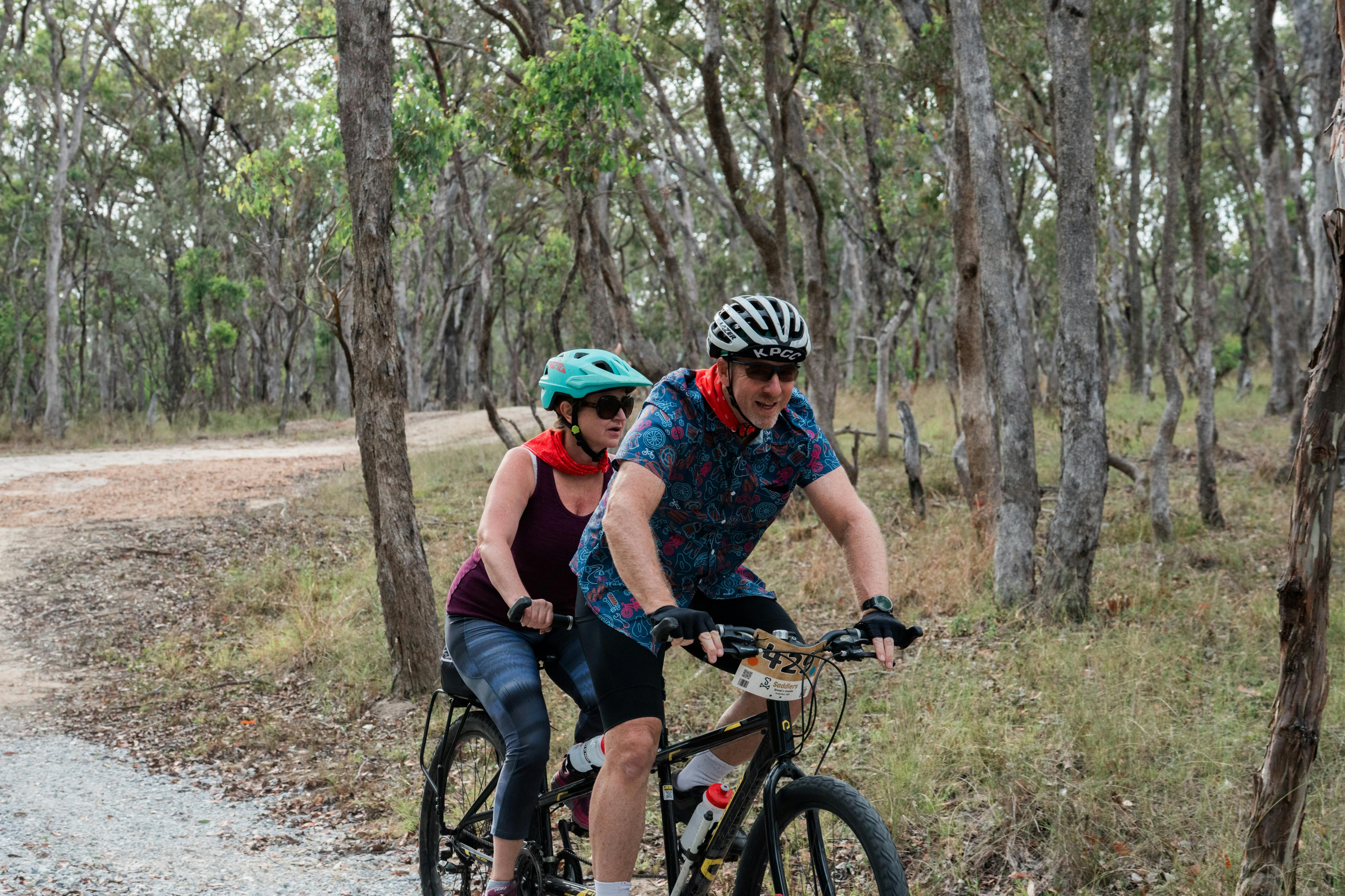A man and vision impaired women ride on a tandem bike through Curry