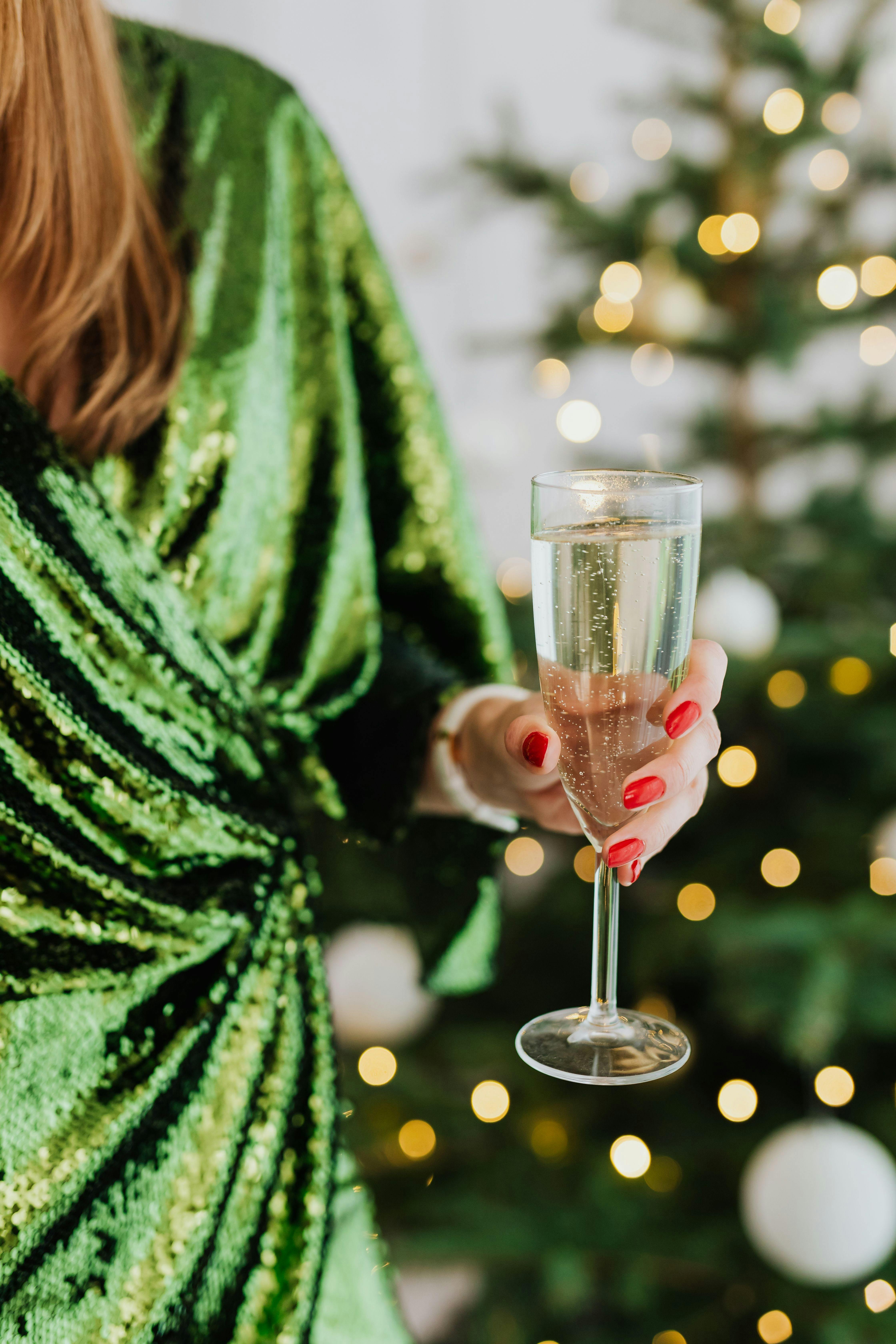 Festive photo of a lady holding sparkling wine