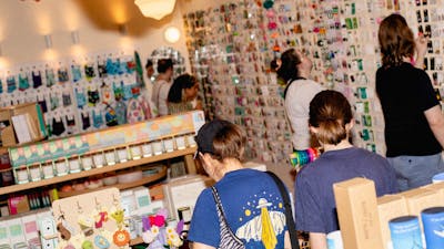 Shoppers exploring a vibrant selection of locally made goods, candles, keychains, and more.